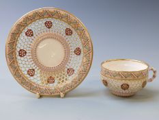 Royal Worcester reticulated enamelled and jewelled cup and saucer with fine gilt decoration on a