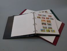 Eight albums of Channel Islands and Isle of Man stamps, mint and used