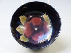 William Moorcroft pedestal bowl in Pansy pattern on a navy blue ground, diameter 13.5cm