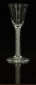 An 18thC clear drinking glass with opaque double twist stem and ogee shaped bowl raised on conical