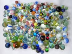 Over 200 various glass marbles with various multi-cloured twists, largest 33.3mm in diameter.