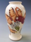 Moorcroft pedestal baluster vase decorated with butterflies and flowers, 26cm tall