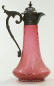 Cranberry glass water jug with wrythen molded body and silver plated mounts, 29cm tall.