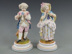 Pair of late 19thC/20thC German porcelain figures of children holding a bird and nest, 22cm