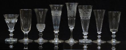 Eight 19thC and later champagne flutes/glasses, all with cut or engraved decoration, largest 18.2cm.