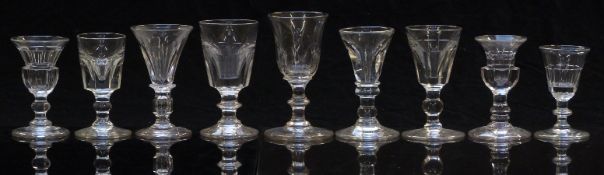 Nine 19thC and later clear drinking glasses all with cut decoration and knopped stems, largest