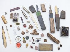 Collection of badges including Cheltenham Steeplechase Club, Heidsieck Dry Monopole pocket knife,