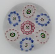 Clichy patterned millefiori glass paperweight with seven rings of red, blue and white canes