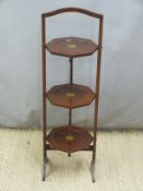 Octagonal mahogany folding plate stand, height 88cm