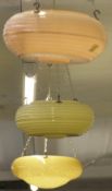 Three retro glass plafonniers one yellow ribbed example, another similar in pink and one mottled,