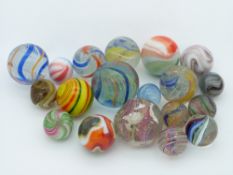 Nineteen glass marbles some with latticino twists and some agate and onionskin style, largest 29mm