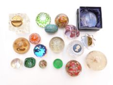 Seventeen various glass paperweights including one in the form of a table lighter, multi-faceted