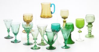 Fourteen coloured drinking glasses including seven German, Dutch or similar green and amber