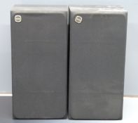 A pair of Tannoy stereo speakers No. 966700 in black woodgrain finish with wall bracket fittings