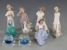 A collection of Nao figures and paperweights, tallest 20cm