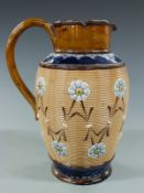 Doulton Lambeth jug decorated with flowers in relief, impressed EG to base, 21cm tall