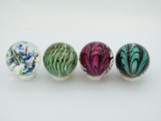 Four Teign Valley Glass (TVG) glass marbles two with web decoration and two with controlled bubbles,