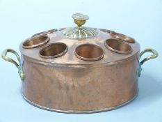 A 19thC copper and brass wine cooler/ ice bucket with eight removable copper beakers, twin brass