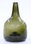 An 18thC green glass onion wine bottle, 23cm tall.