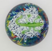 Baccarat style glass paperweight decorated with a green lizard on a mottled ground over blue base,