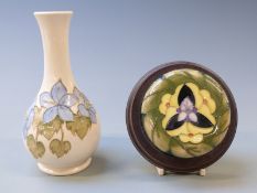 Moorcroft pedestal bottle vase decorated with flowers, 16cm tall and a Moorcroft ginger jar lid
