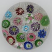 Clichy spaced millefiori glass paperweight with various multi-coloured canes and roses on