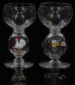 A pair of novelty clear glass drinking glasses both with bulbous knops one containing a chicken