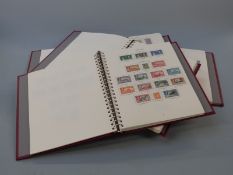 A boxed set of four Stanley Gibbons King George VI stamp albums. Mint and used stamps including high