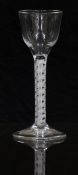 An 18thC clear drinking glass with opaque double twist stem and ogee shaped bowl raised on conical