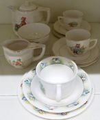 A c1950s childs nursery teaset comprising teapot, two cup, saucer and plate trios, sugar basin and