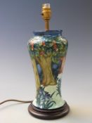 Moorcroft table lamp with tube lined decoration of trees and flowers, 38cm tall