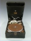 HMC c1930s portable wind up gramophone, ivorine plaque within Milsom's gramophone specialists, Bath,