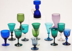 Fourteen coloured glass drinking glasses inclusing amethyst, Bristol blue etc, one in the form of
