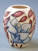 Moorcroft vase decorated with blue flowers on a cream ground, initialled JW and dated 2004 to