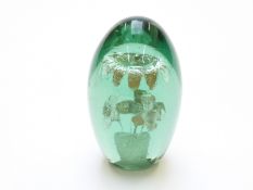 Nailsea green glass dump paperweight decorated with flowers, 13cm tall.