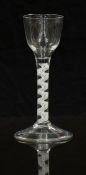 An 18thC clear drinking glass with opaque double twist stem and ogee shaped bowl raised on conical