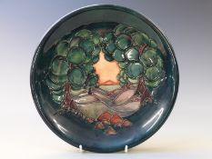 Moorcroft charger decorated with a landscape, diameter 26cm