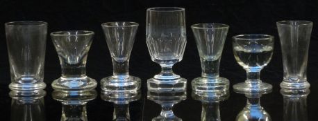 Seven various 19thC and later clear firing glasses, one with faceted decoration, largest 11.1cm