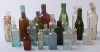 Twenty three various glass bottles including Spencer's West Bromwich, Masons Wine Essences