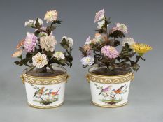 A pair of French jardinières with faux floral decoration in the form of metal branches and porcelain