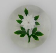 Baccarat faceted glass flower paperweight decorated with a white clematis with central pink and