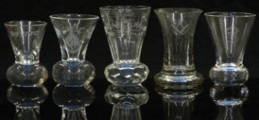 Five various 19thC and later clear firing glasses all with Masonic and similar engraved decoration