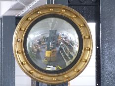 Regency convex butler's mirror with gilt frame and applied spheres, diameter 57cm overall