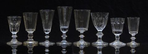 Eight 19thC and later clear cut glass drinking glasses, all with single knopped stems, one with