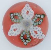 Clichy style patterned millefiori glass paperweight with multi coloured canes in the form of a