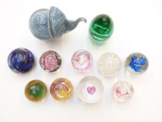 Eleven Caithness, Wedgwood and similar glass paperweights including one in the form of an