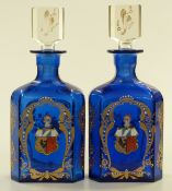 A pair of blue glass armorial decanters with gilded and enamelled decoration, height 26cm