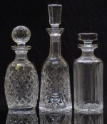 Three Waterford Crystal cut glass decanters, one with original paper label, largest 33cm tall