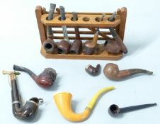 A collection of vintage pipes including Meerschaum, briar etc, and a pipe rack