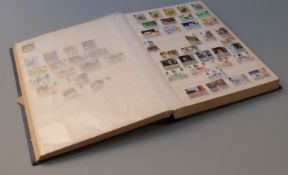 A large stockbook of GB stamps, mainly QEII but including mint George VI blocks